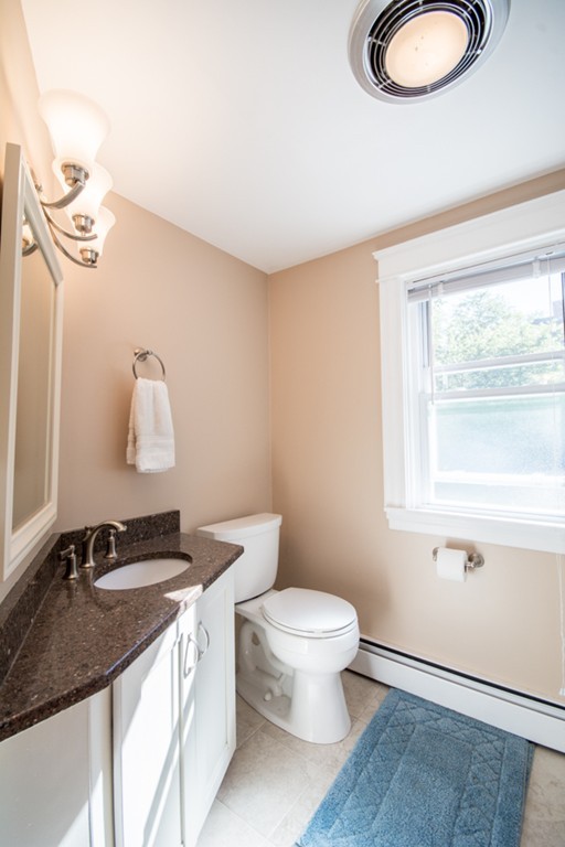 44 Bridge Street Warren, RI 02885 - Photo 7 of 30 a bathroom with a granite countertop sink and a mirror