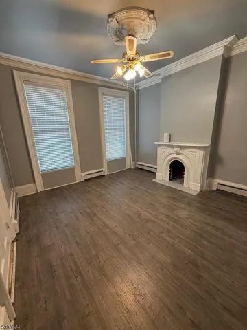 a view of livingroom and kitchen with wooden floor