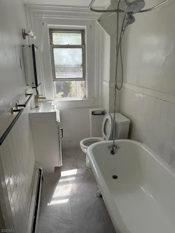 a bath tub sitting next to a window