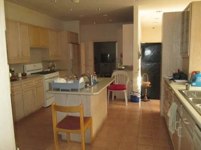 a spacious bathroom with a sink and a mirror
