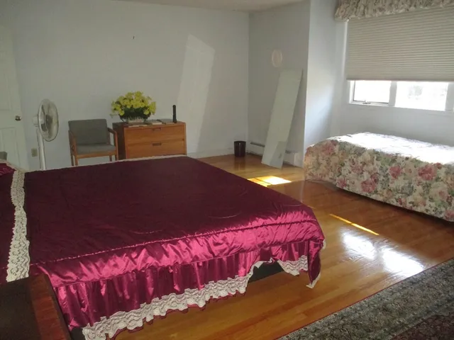 a bedroom with a bed and window