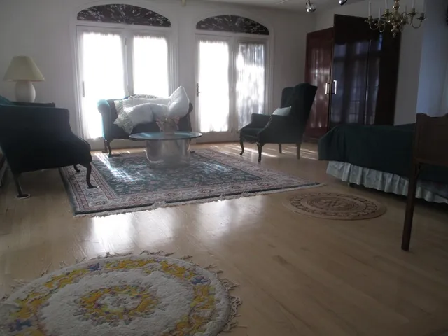 a living room with furniture and a floor to ceiling window