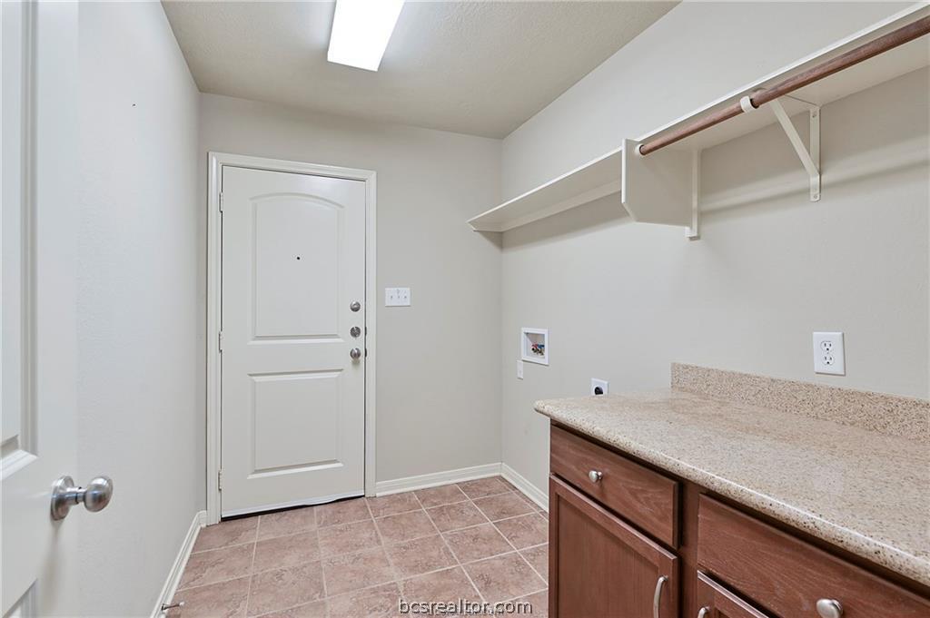 2004 Spring Leaf Court Bryan, TX 77807 - Photo 12 of 19 Clothes washing area with light tile patterned floors, baseboards, electric dryer hookup, laundry area, and washer hookup
