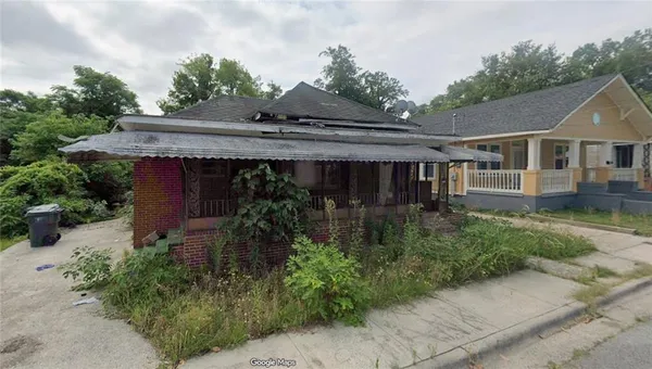 a front view of house with a garden