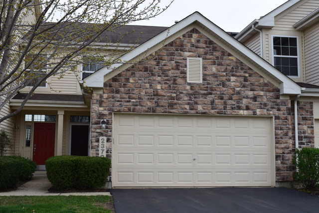 2370 Georgetown Circle, Unit 2370 Aurora, IL 60503 - Photo 1 of 21 a view of a house with garage and plants