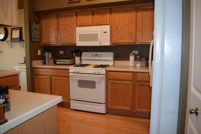 2370 Georgetown Circle, Unit 2370 Aurora, IL 60503 - Photo 12 of 21 a kitchen with a stove and a microwave