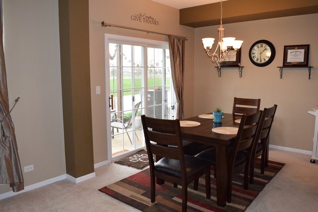 2370 Georgetown Circle, Unit 2370 Aurora, IL 60503 - Photo 8 of 21 a view of a dining room with a table and chairs
