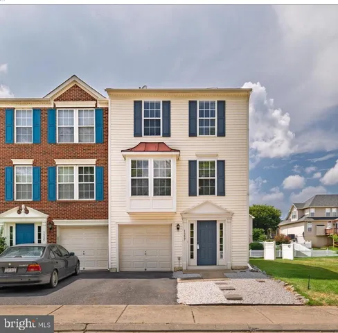a front view of a residential houses with yard