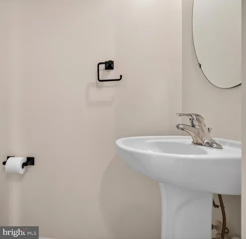 a bathroom with a sink and mirror