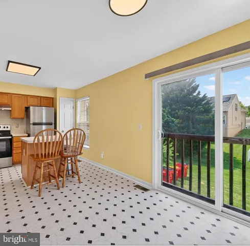 a view of a bedroom with furniture and balcony