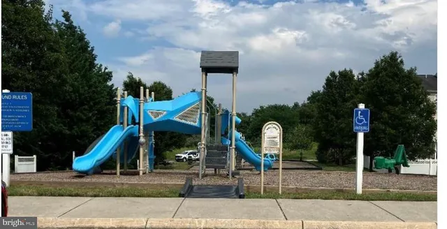 a front view of a house with garden and plants