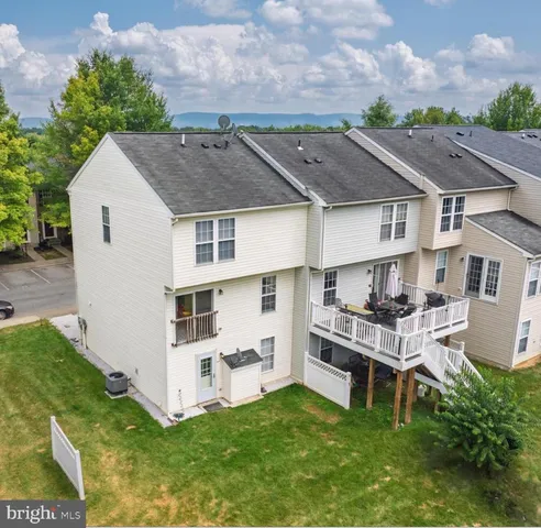 a view of a house with a sink and a yard with potted plants