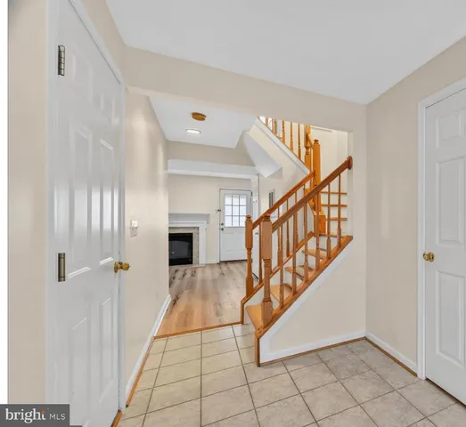 a view of an entryway with wooden floor and staircase