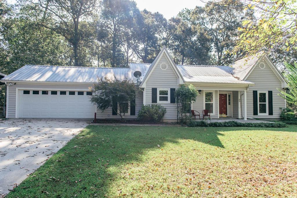 201 Red Oak Road Byron, GA 31008 - Photo 1 of 29 a front view of a house with a garden and trees