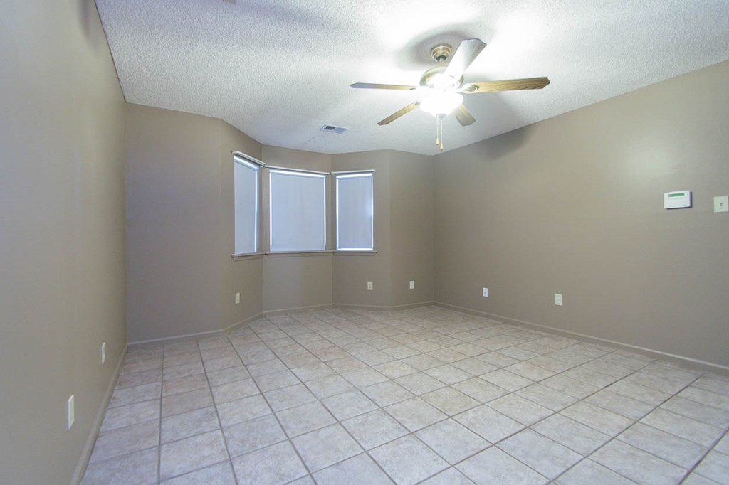 201 Red Oak Road Byron, GA 31008 - Photo 11 of 29 an empty room with chandelier fan and window