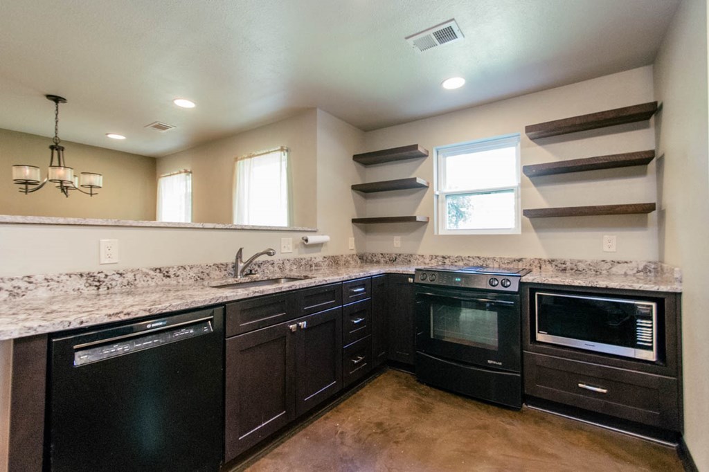 201 Red Oak Road Byron, GA 31008 - Photo 8 of 29 a kitchen with stainless steel appliances granite countertop a sink and stove top oven