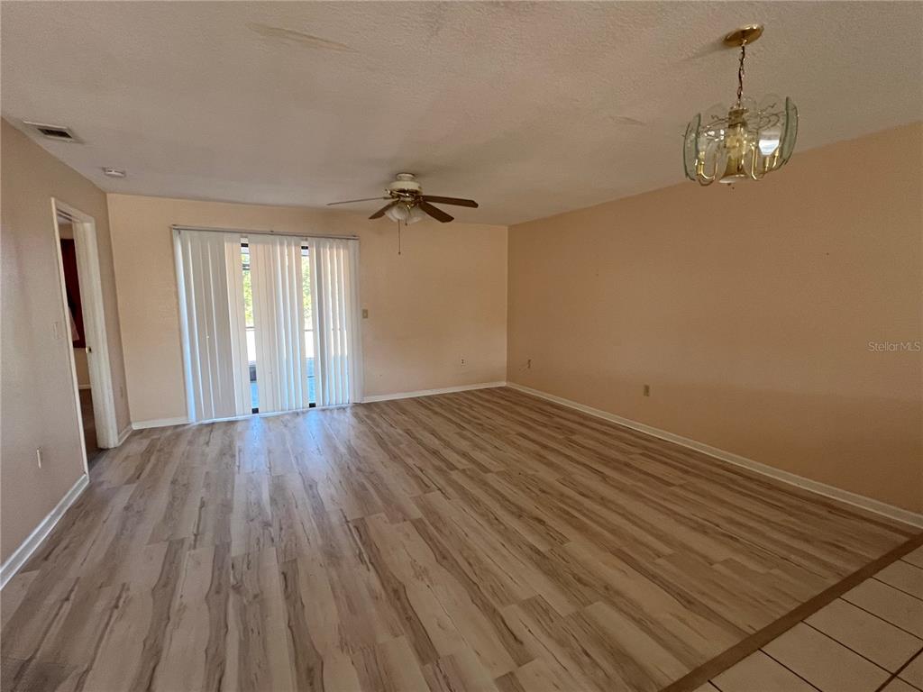 27082 Adams Street, Unit A Punta Gorda, FL 33983 - Photo 4 of 8 wooden floor in an empty room with a window