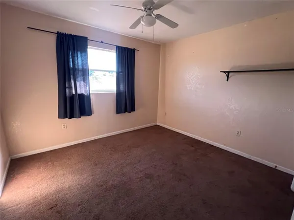 an empty room with windows and closet