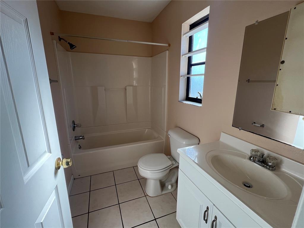 27082 Adams Street, Unit A Punta Gorda, FL 33983 - Photo 7 of 8 a bathroom with a sink toilet and shower
