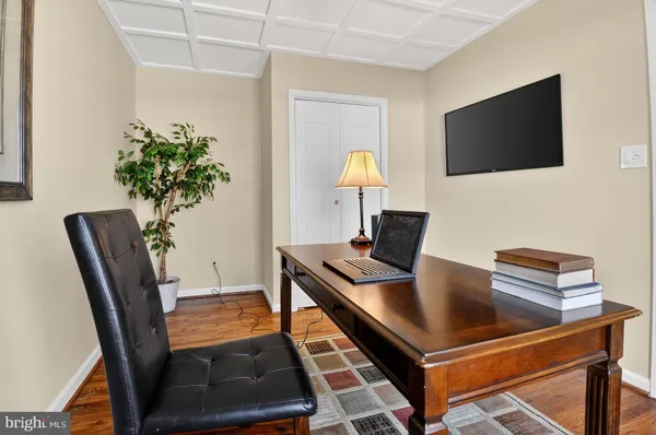 a room with painting on the wall and wooden floor