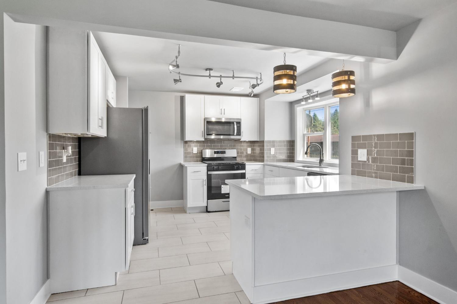 4895 Cherry Street Griffith, IN 46319 - Photo 12 of 21 a kitchen with stainless steel appliances granite countertop a sink and a stove