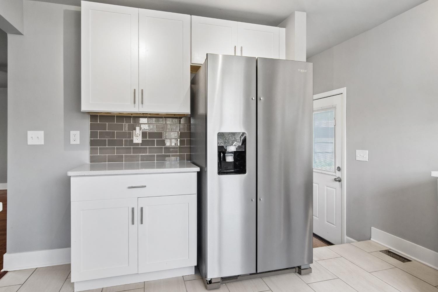 4895 Cherry Street Griffith, IN 46319 - Photo 13 of 21 a kitchen with stainless steel appliances a refrigerator and cabinets