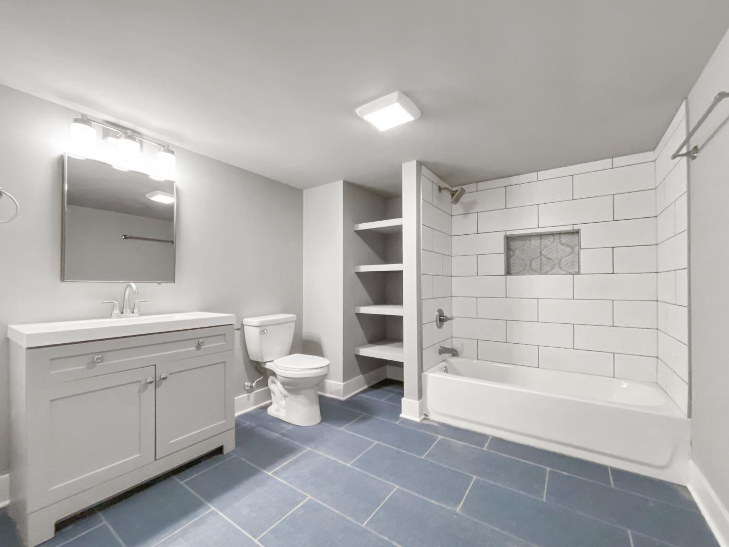 4895 Cherry Street Griffith, IN 46319 - Photo 21 of 21 a bathroom with a bathtub shower sink mirror and toilet