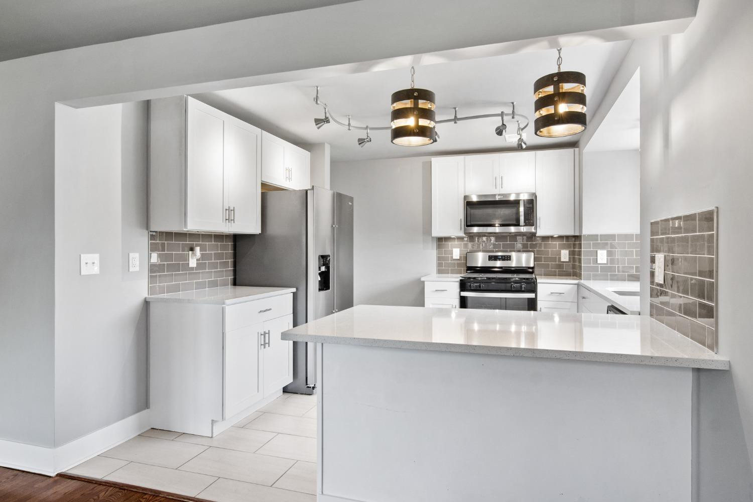 4895 Cherry Street Griffith, IN 46319 - Photo 3 of 21 a kitchen with stainless steel appliances a refrigerator sink and stove