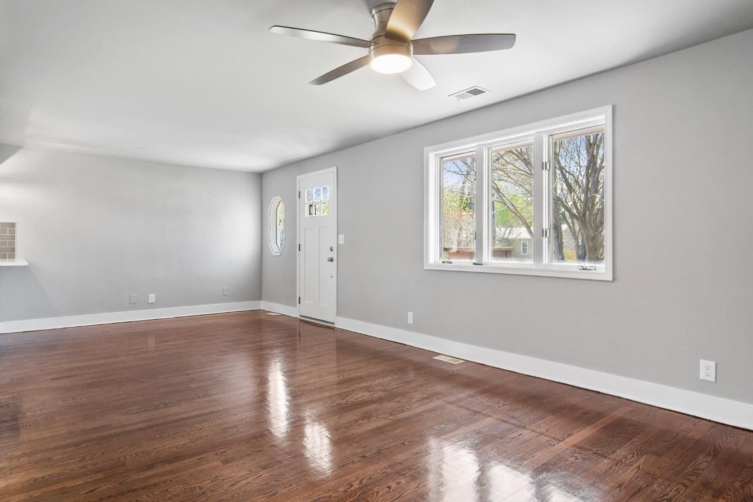 4895 Cherry Street Griffith, IN 46319 - Photo 10 of 21 a view of empty room with wooden floor and fan