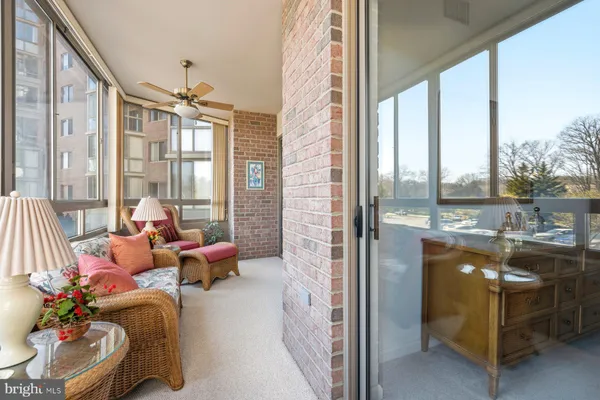 a dining room with furniture water view and a floor to ceiling window