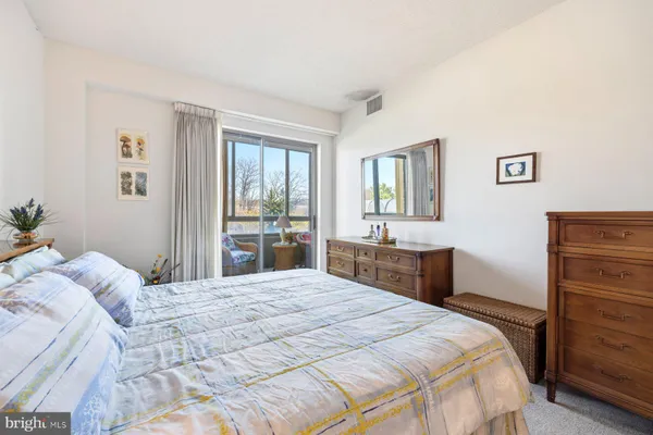 a bedroom with a large bed and a dresser