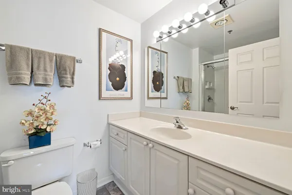 a bathroom with a sink mirror and vanity