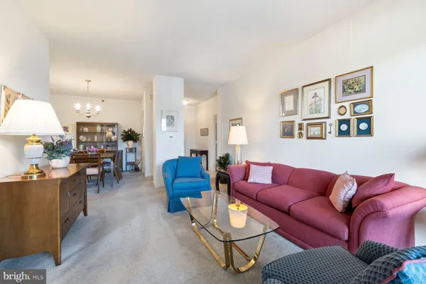 a living room with furniture a ceiling fan and a window