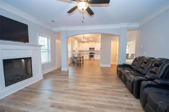 a living room with furniture fireplace and flat screen tv
