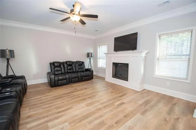 a living room with furniture fireplace and flat screen tv
