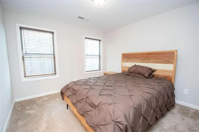 a bedroom with a bed and window