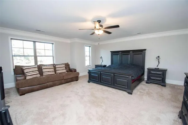 a living room with furniture a ceiling fan and a window