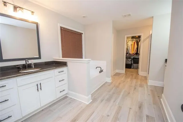 a bathroom with a sink and mirror