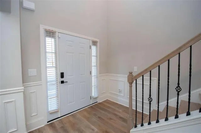 a view of an entryway with wooden floor