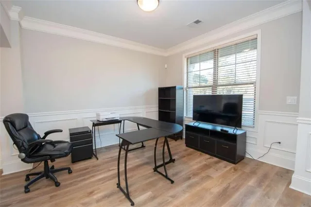 a view of a livingroom with furniture and a flat screen tv