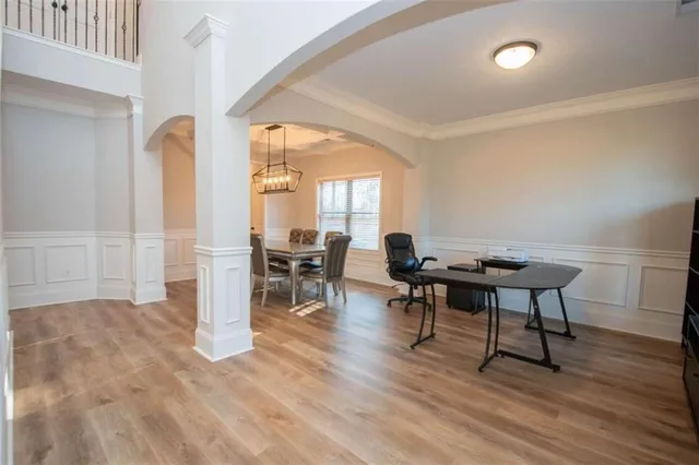 a workspace with furniture window and wooden floor