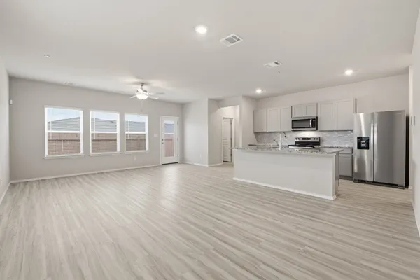 a view of a hallway with closet and livingroom
