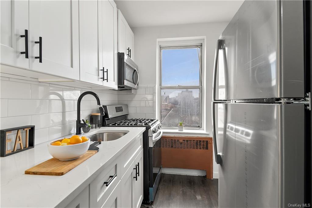 a kitchen with stainless steel appliances a sink cabinets and a refrigerator