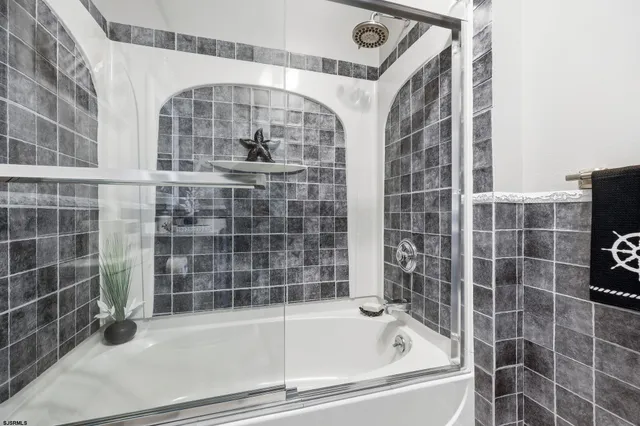 a bathroom with a bathtub and a shower