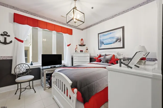 a bedroom with furniture and a flat screen tv