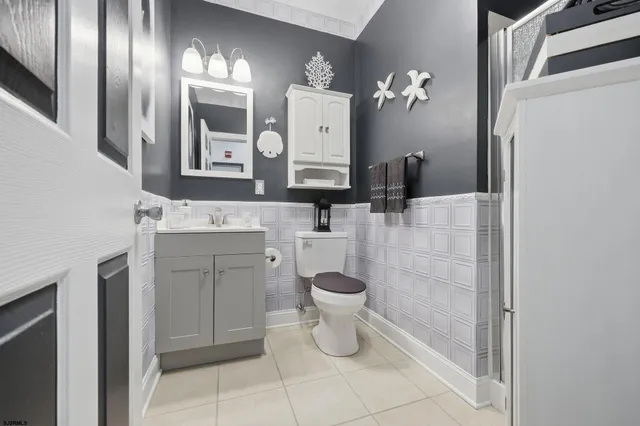 a bathroom with a toilet sink and mirror