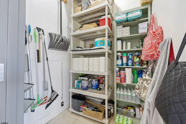 a view of water heater room with clothes