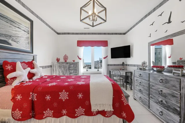 a bedroom with a bed and flat screen tv