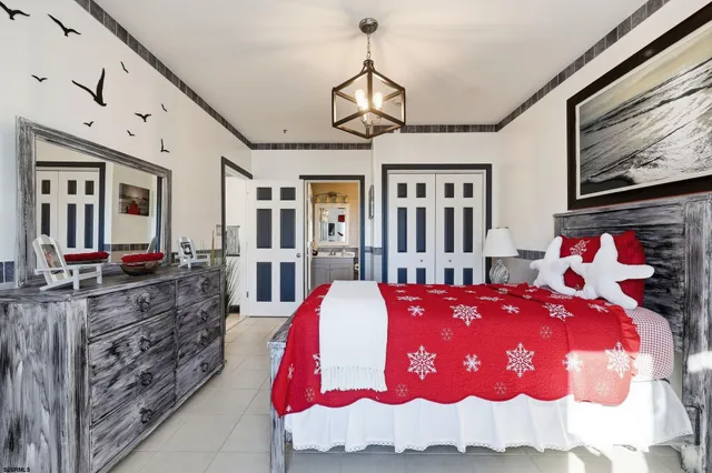 a bed room with a bed mirror and a dresser