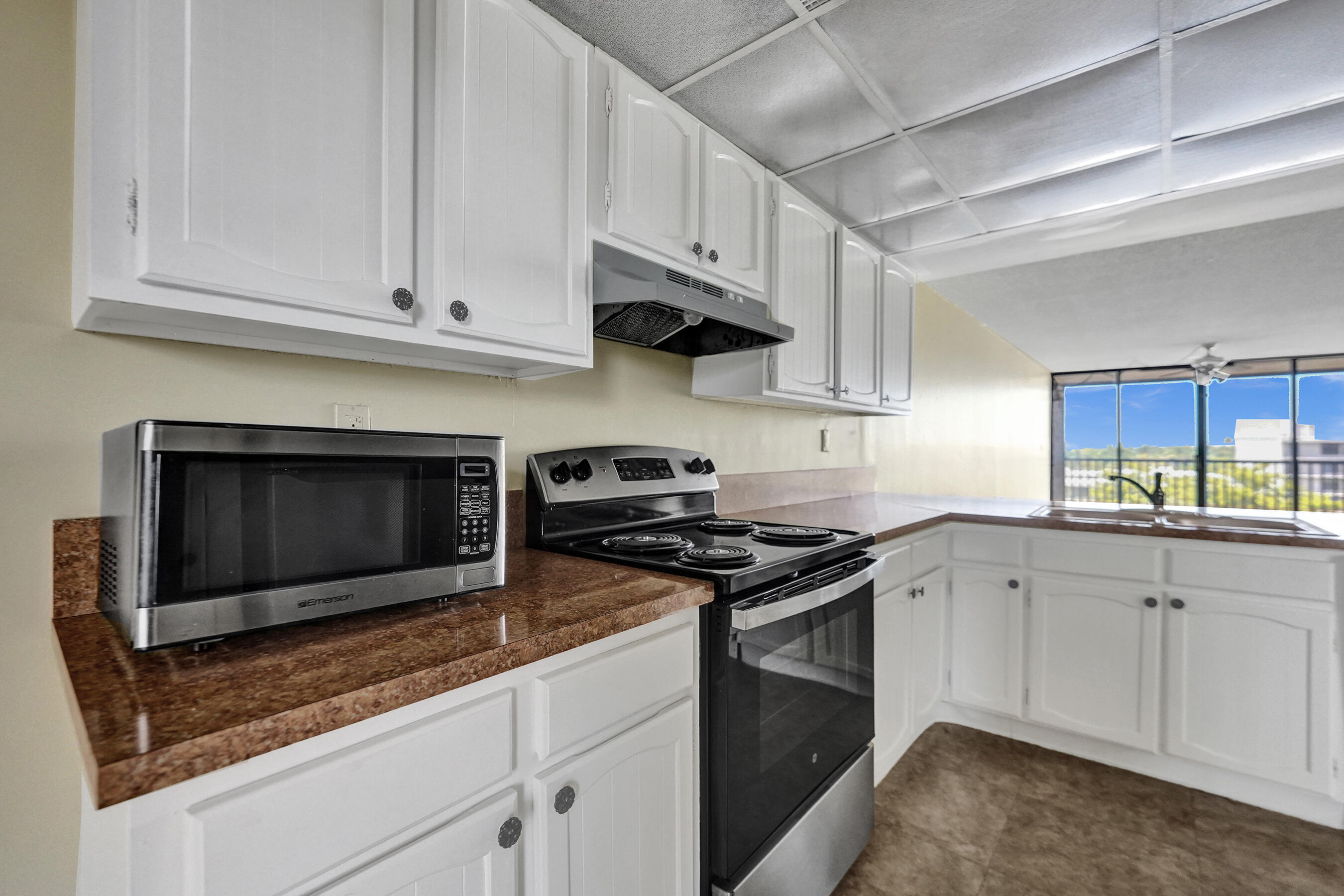 12 Royal Palm Way, Unit 6020 Boca Raton, FL 33432 - Photo 12 of 69 a kitchen with stainless steel appliances granite countertop a stove a sink and a microwave